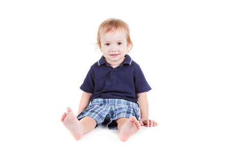 Cute little white boy smiling sitting. isolated on white background.の写真素材