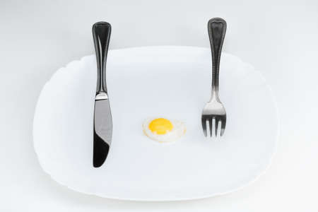 Diet concept, small eggs on a white plate, low-calorie breakfastの写真素材