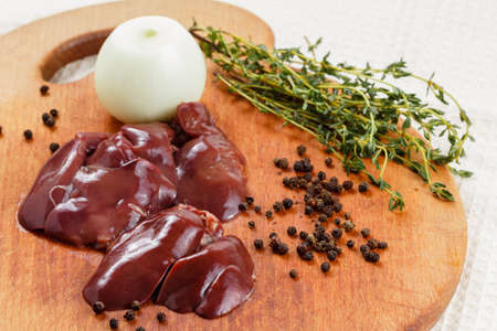 Fresh raw chicken liver with spices on cutting board. Cooking food.の写真素材