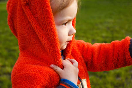 Young boy exploring nature in a meadow. Closeup portraitの写真素材