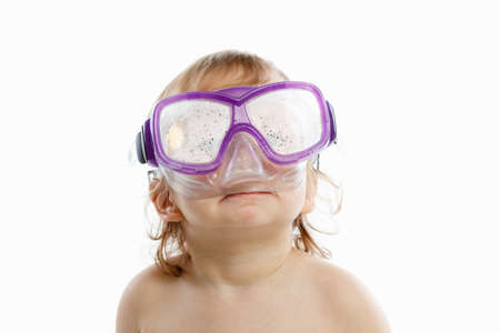 Baby diver in swimming mask with a happy face close-up portrait, on white background.の写真素材