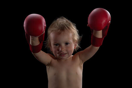 Boy athlete, boxer or kickboxer gloves training. Black background.の写真素材