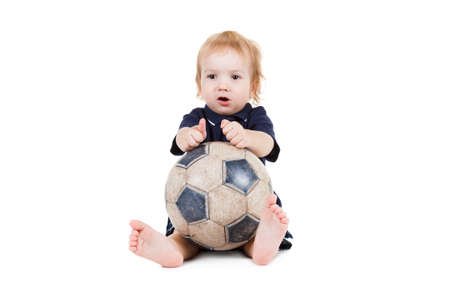 Baby boy playing with a soccer ball. Isolated on white backgroundの写真素材