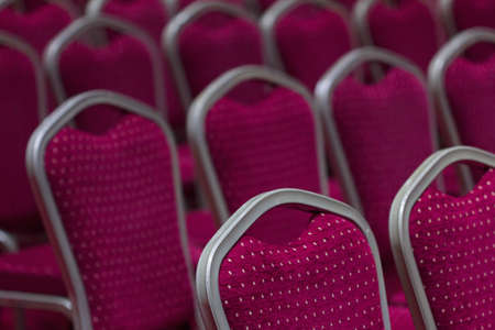 Rows of new empty chairs in the spacious conference hallの写真素材