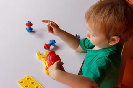 kid child boy playing with toys tools in kindergartenの写真素材
