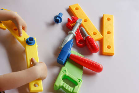 kid child boy playing with toys tools in kindergarten