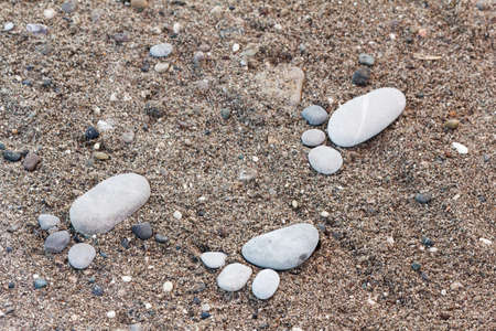 Group of foot by pebble on sand background, concept from stone on beach, awesome artの写真素材