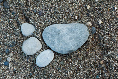 Group of foot by pebble on sand background, concept from stone on beach, awesome artの写真素材