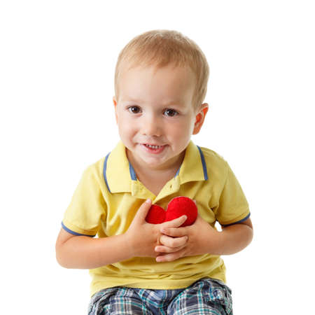 Little caucasian child with a heart symbol isolated on white. Concept of love, tenderness and health.の写真素材