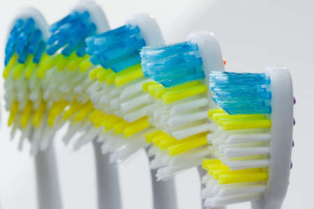 Set of colorful toothbrushes over white closeup