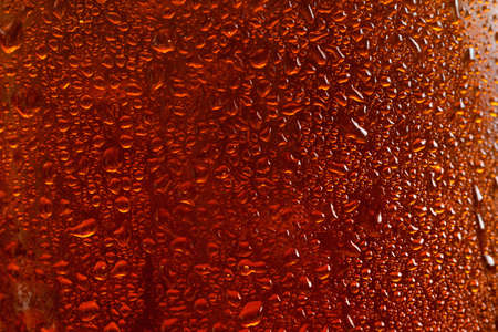 Beer background, macro flowing drops on the glass with bubbles, brown ale.の写真素材