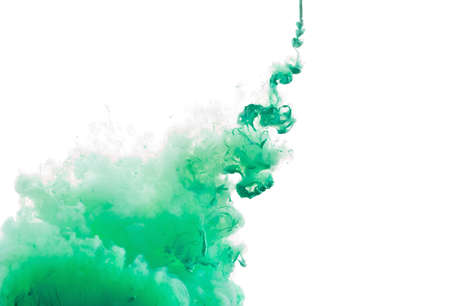 Color Ink in water, photographed in motion. Swirling paint drop watercolor. Cloud isolated on white background.の写真素材