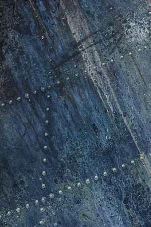 Old aluminum background detail of a military aircraft, surface corrosion. Oxidized metal texture with rivets.の写真素材
