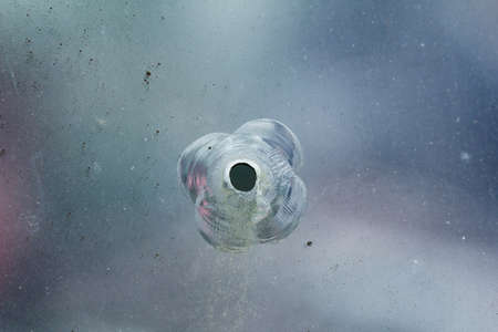 Firearms bullethole on the glass from the bullets, cracks and broken background. Criminal conceptの写真素材