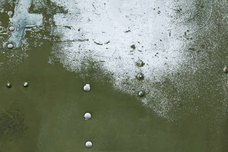 Old painted metal background detail of a military aircraft, surface corrosion, metal texture with rivets.の写真素材