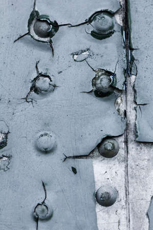 Old painted metal background detail of a military aircraft, surface corrosion, metal texture with rivets.の写真素材
