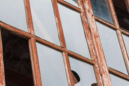 broken glass window ruins in an abandoned old houseの写真素材