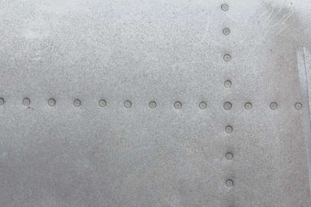 Old aluminum background detail of a military aircraft, surface corrosion. Oxidized metal texture...