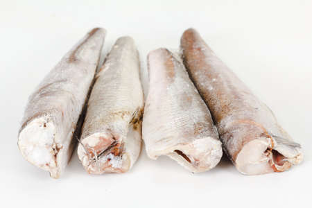 frozen hake fish on a white background closeupの写真素材