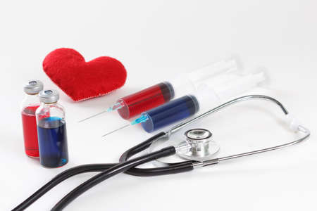 Stethoscope, syringe and heart. Healthcare concept on whiteの写真素材