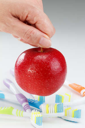 apple with a toothbrush, on white. healthy dental care conceptsの写真素材