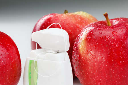 Dental teeth floss and red apple. Health care conceptの写真素材