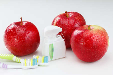 Dental teeth floss, toothbrush and red apple. Health care conceptの写真素材