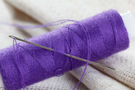 Needlework and handmade, linen fabric with needle and threadの写真素材