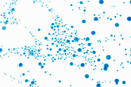 Bubbles of paint on a white background, abstract pattern of blue ink drop. Random art.