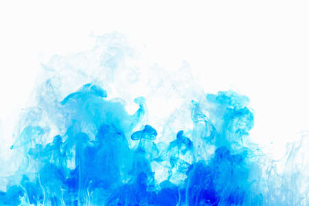 Abstract background color ink drop in water, motion swirling. Blue cloud of paint on white.の写真素材