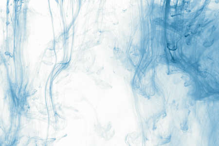 Smoke abstract background cloud of paint on white. Color ink drop in water, motion swirling closeup.の写真素材