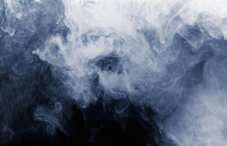 Abstract cloud pattern of white smoke on a black background. Waves of mist.の写真素材