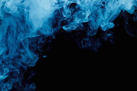 Abstract blue cloud pattern of white smoke on a black background. Waves of mist.の写真素材