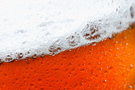 Background beer with foam and bubbles macro