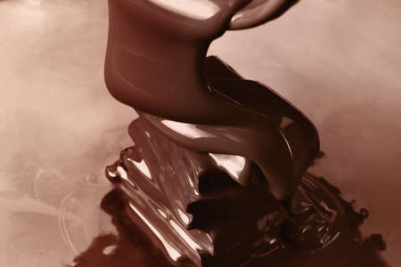 Pouring liquid hot chocolate from above closeup. Cooking dessert.の写真素材