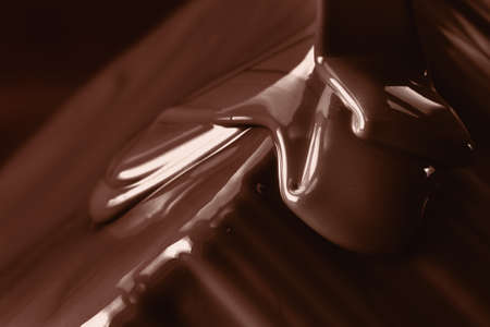Pouring liquid hot chocolate from above closeup. Cooking dessert.の写真素材