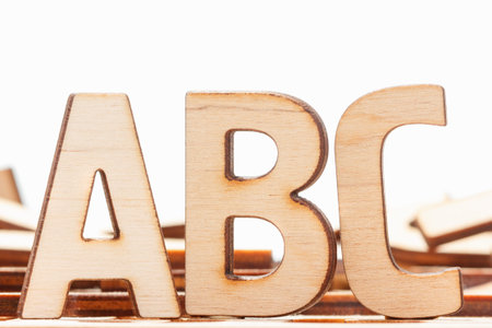 Alphabet made of wooden letters on wood background