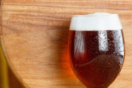 Beer glass pint with copy-space on wooden background. Mug closeupの写真素材