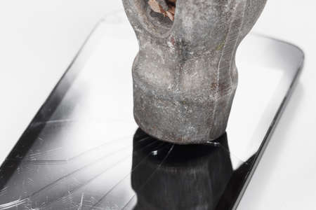 Crack glass display of the smartphone or a tablet, the result of falling, hitting or damaging the hammer.の写真素材