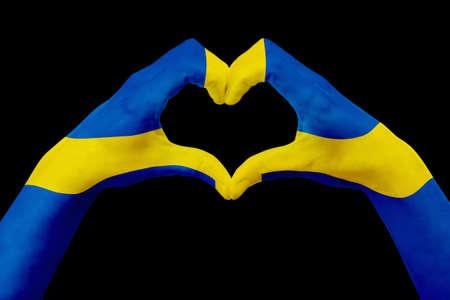 Hands flag of Sweden, shape a heart. Concept of country symbol, isolated on black. Abstract 3d illustration graphic, design with pattern and texture.の写真素材