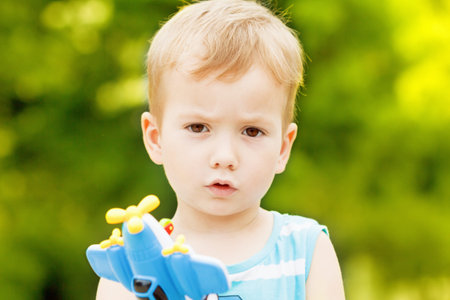 happy child toddler boy playing with toy airplane and dreaming of becoming a pilot