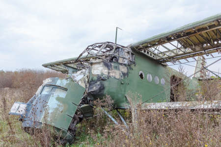 Old broken green russian airplane on the fieldの写真素材
