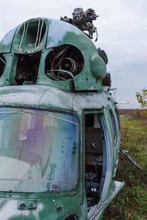 Old broken green russian helicopter on the fieldの写真素材