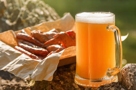Octoberfest mug beer with food on natural background.の写真素材