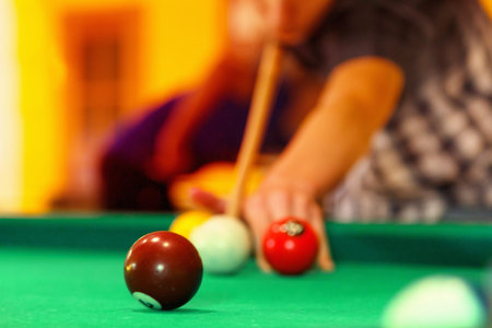 Playing man by cue in billiard pool party.