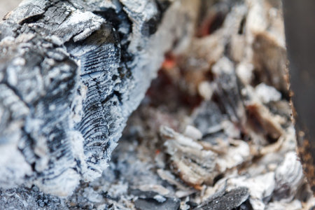 Glowing hot charcoal briquettes close-up background texture. bonfire coals