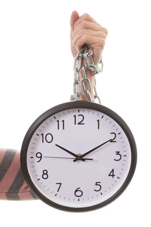 Hand holding an alarm wall clock. Business time management conceptの写真素材