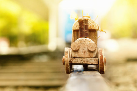 Concept design autumnal mood, yellow foliage on a background and a toy train.