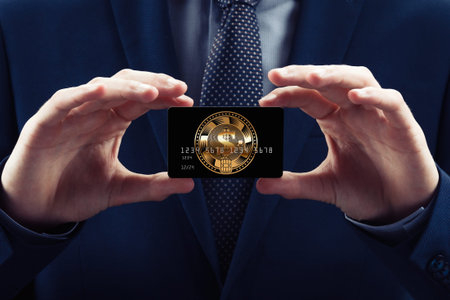 Businessman in costume and necktie hold credit card, with cryptocurrency. Isolated concept block chain bit coin of e-businessの写真素材