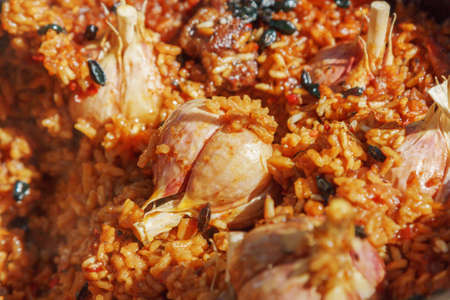 Preparation of pilaf on fire. Tourist bowler with food on bonfire, cooking in the hike, outdoor activities.の写真素材